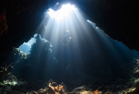 Discovering Nature - a sunbeam shines through a cave in the ocean