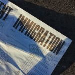 Immigration's Impact - white printed paper
